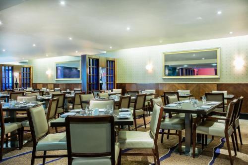 a dining room filled with tables and chairs at Crowne Plaza London Ealing by IHG in London