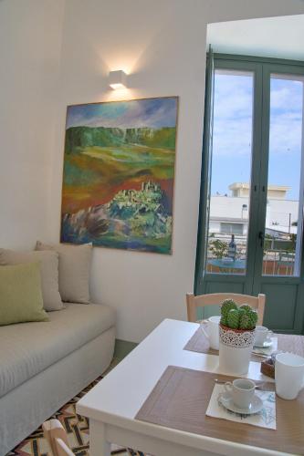 a living room with a couch and a table at Casa Zizzi - appartamento romantico per 2 in Puglia in Montalbano