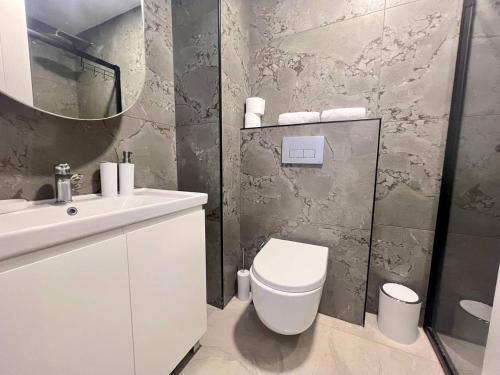 a bathroom with a toilet and a sink and a mirror at Boutique 16 - Alanya Experience in Alanya