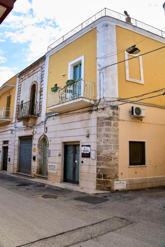 an old building with two balconies on a street at Casa Zizzi - appartamento romantico per 2 in Puglia in Montalbano