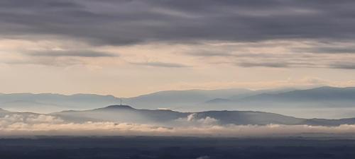 a view of a mountain range with clouds in the sky at Avalon II in Thannenkirch