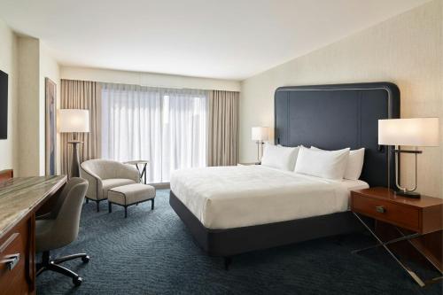 a large hotel room with a bed and a desk at JW Marriott Austin in Austin