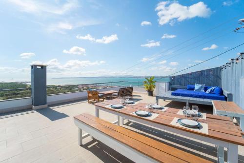 a patio with a table and chairs on a balcony at Dreamview Nest | By Airnest in Trafaria