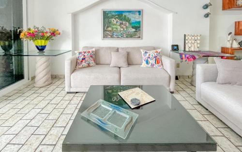 a living room with a couch and a table at Playa Bonita unit Beso del Sol 101 in Puerto Vallarta