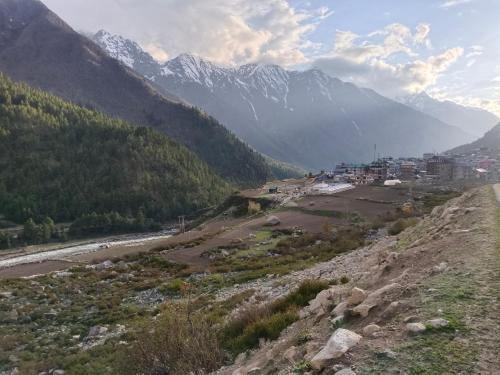 a view of a valley with a river and mountains at RR Homestay Chitkul in Chitkul