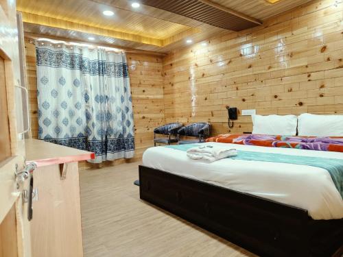 a bedroom with two beds in a wooden cabin at RR Homestay Chitkul in Chitkul
