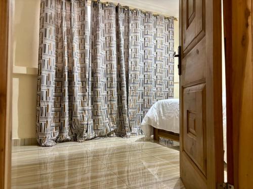 a bedroom with a shower curtain and a bed at Veranda Vista in Trofwi