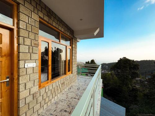 a balcony of a house with a view at Tara Van in Dharamshala