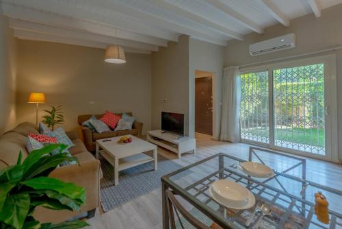 a living room with a couch and a tv at Luxury Villa with private garden in Cairo