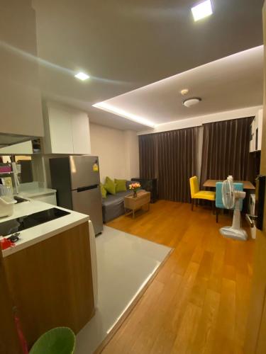 a kitchen and living room with a couch and a table at CozyroomSukumvit13walktoBTS,MRT in Bangkok