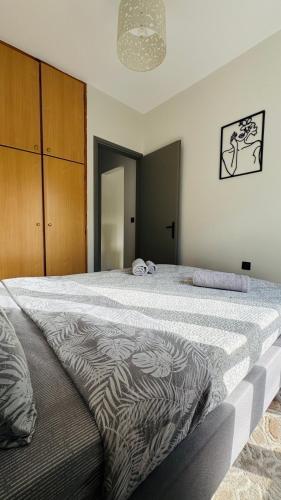 a bedroom with a large bed with a zebra blanket at Melinda’s cozy apartments in Plomarion
