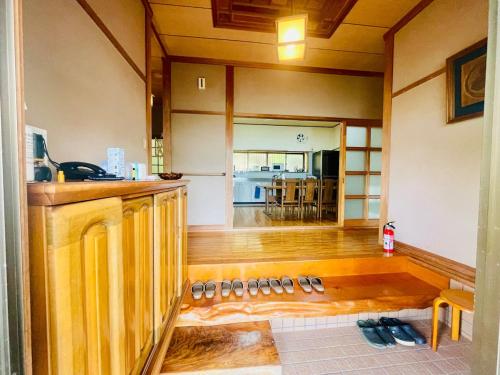 a kitchen with wooden floors and a kitchen with a counter top at ぽつんとオーシャンビューでバーベキューも出来る1日1組貸切宿カゴヤブハウス in Otsuki