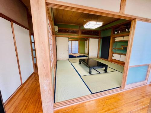 an empty room with a large window in a house at ぽつんとオーシャンビューでバーベキューも出来る1日1組貸切宿カゴヤブハウス in Otsuki