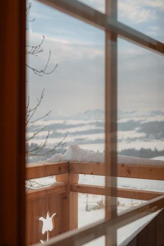 a window with a view of the snow covered ground at Marusina Chalets in Szaflary