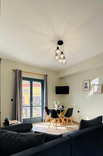 a living room with a couch and a table at Melinda’s cozy apartments in Plomarion