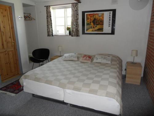 a bedroom with a large bed and a window at Motel Herning in Kibæk