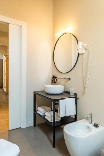 a bathroom with a sink and a mirror at Residenza Dell' Opera in Turin