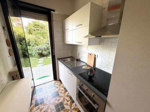 a small kitchen with a sink and a window at Suite Mazzini 177 - Sanremo in Sanremo