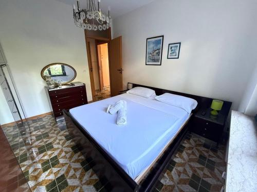 a bedroom with a large white bed with a mirror at Suite Mazzini 177 - Sanremo in Sanremo