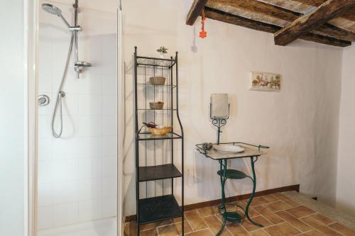 a bathroom with a shower and a stool and a table at Dimora Bruschi in Pergola