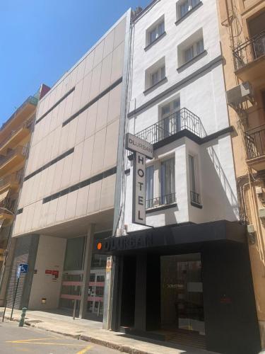a white building with a sign in front of it at Hotel DL Urban in Castellón de la Plana