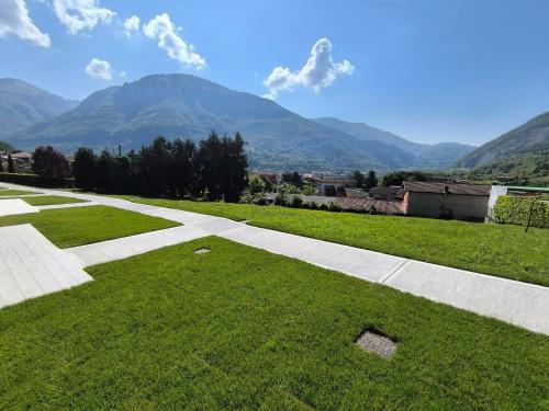 a walkway in a field with mountains in the background at BEDE-Bike in Casazza