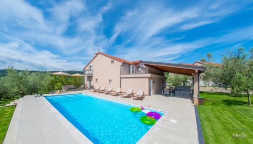 a swimming pool in the backyard of a house at Holiday Home The Olive Escape in Stolac