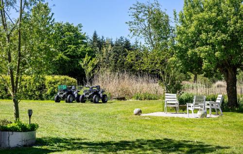 a park with two atvs parked in the grass at Beautiful Home In Nibe With Sauna in Nibe