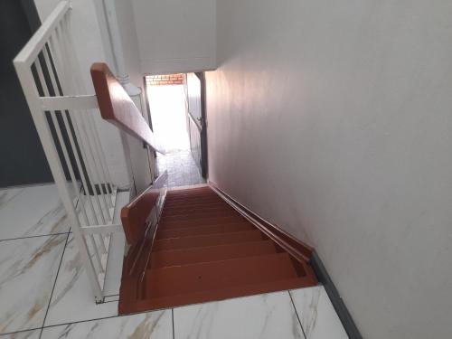 a stairway with a stair case in a building at Silent Night Guest House Sunnyside Pretoria in Pretoria