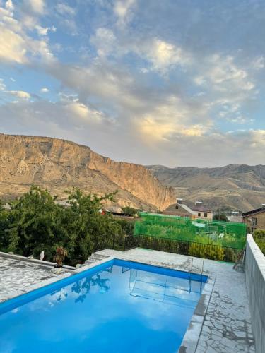 a swimming pool with a view of the mountains at Rockside House Areni in Areni