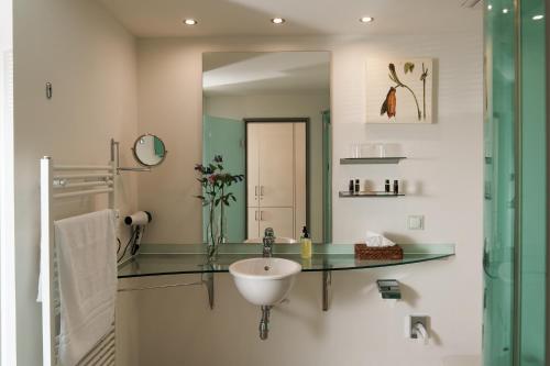 a bathroom with a sink and a mirror at Hotel Meersinn - Binz in Binz