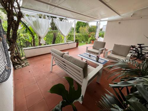 a patio with a bench and a table and chairs at Casa de la Luna in Nettuno