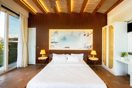 a bedroom with a large bed and a painting on the wall at Kyomi Retreat-Mukteshwar in Mukteswar