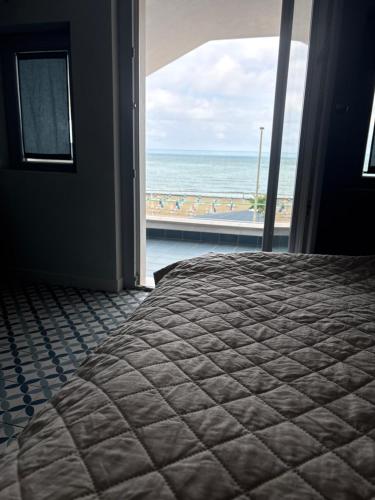 a bedroom with a bed and a view of the ocean at B&B Vista Mare in Rodi Garganico