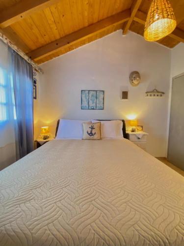 a bedroom with a large bed in a room at Jenoa, sealight house in Agios Nikolaos