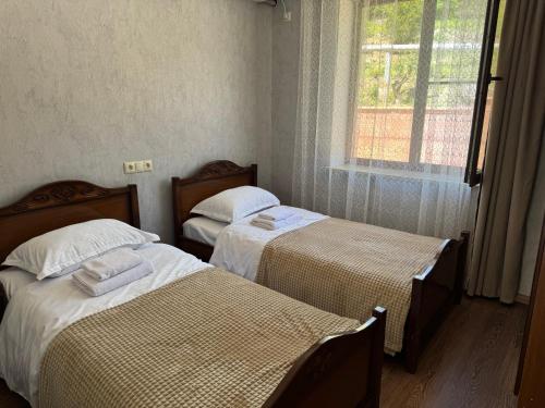 a room with two beds and a window at Rockside House Areni in Areni