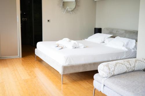 two beds in a room with white towels on them at Hotel Carboneras Cabo de Gata Spa in Carboneras