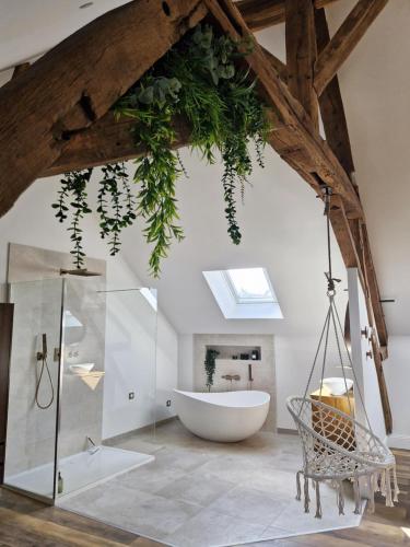une salle de bain avec baignoire et douche en verre dans l'établissement La parenthèse-Logement cosy et Luxueux, à Veuzain-sur-Loire