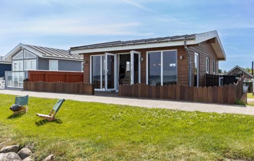a house with a bench in front of it at Amazing Home In Otterup in Otterup