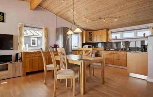 a kitchen with a dining room table and chairs at Amazing Home In Otterup in Otterup