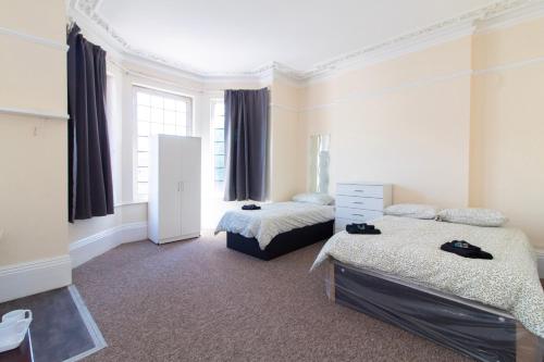 a bedroom with two beds and a window at Brookvale Guest House Room 1 in Southampton