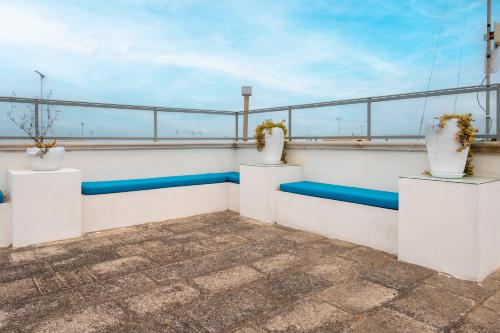 a balcony with three vases on the roof at Case Vacanze Otranto in Otranto