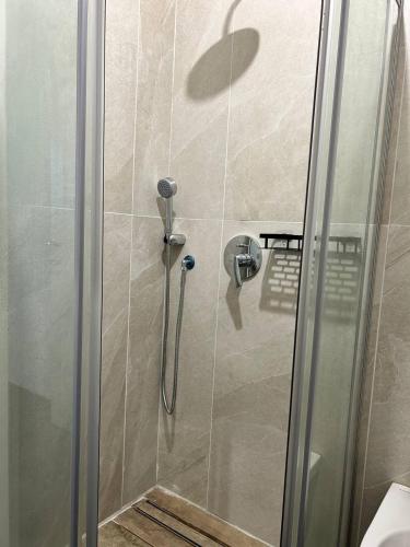 a shower in a bathroom with a glass door at Villa Stella Marina in Porto Cesareo