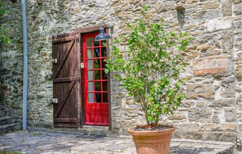 a red phone booth in front of a stone building at Awesome Home In Lohitzun-Oyhercq in Lohitzun-Oyhercq