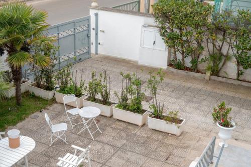 a patio with a table and chairs and plants at Case Vacanze Otranto in Otranto