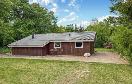 a small cabin in the middle of a yard at Two-Bedroom Holiday Home In Toftlund in Toftlund