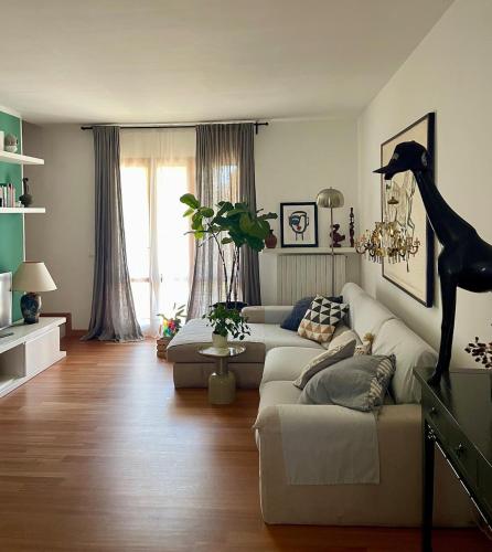 a living room with a couch and a giraffe statue at Casa Mia Sirolo in Sirolo