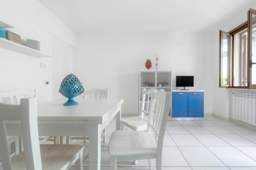 a white dining room with a white table and chairs at Case Vacanze Otranto in Otranto