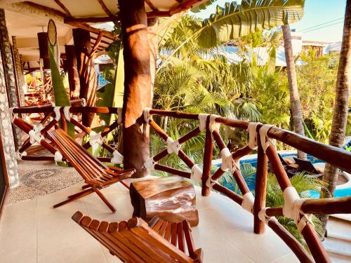 a couple of chairs sitting on a porch at Hotel Para Ti - Adults Only in Holbox Island