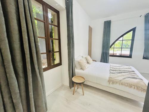 a bedroom with a bed and a window at Gabrielle hôtel in Aiguines